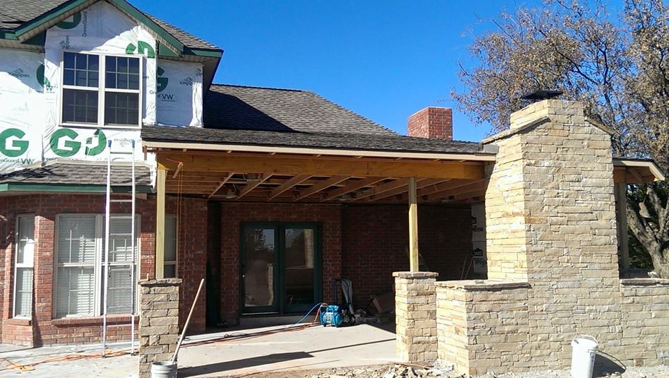 Close up of new gray siding being installed on the side of a home