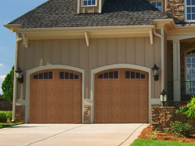 Close up of damaged and loose gray shingles on a residential roof caused by a storm